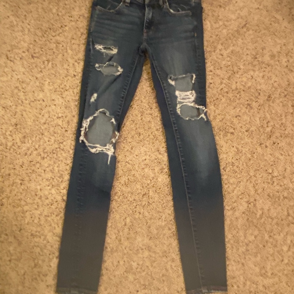 ripped dark blue American eagle skinny jeans